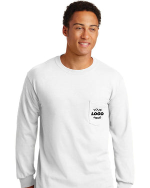 A man wears a plain white Gildan Ultra Cotton Long Sleeve T-Shirt with Pocket, part of a 36-pack (2410), featuring a custom screen-printed logo reading "YOUR LOGO HERE.