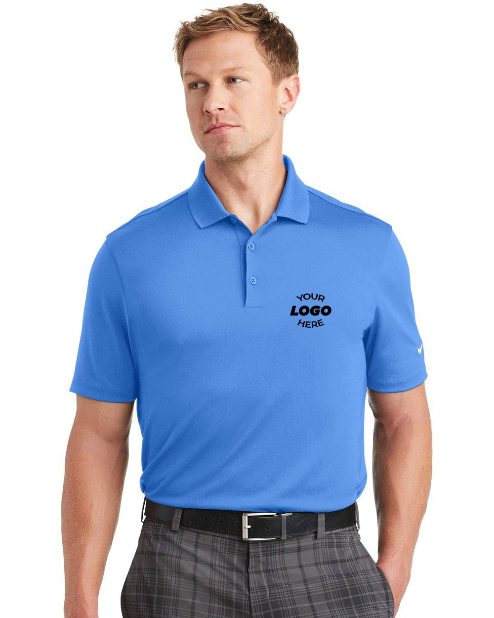 A person in a blue Nike Dri-FIT Classic Fit Players Polo with "Your Logo Here" text stands with hands relaxed, wearing classic fit plaid pants.