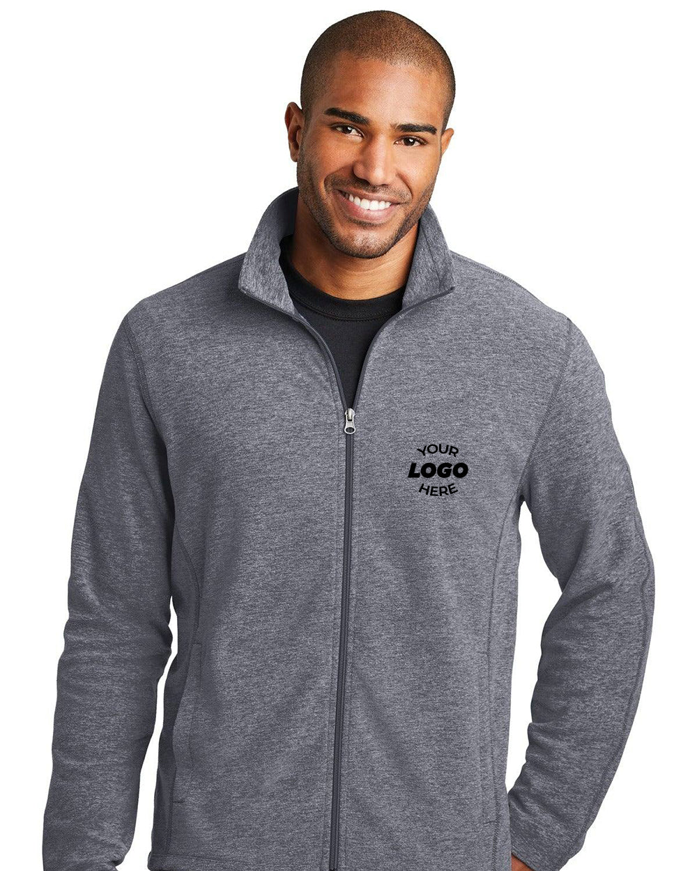 A man stands smiling in a gray Port Authority Heather Microfleece Full-Zip Jacket F235, featuring an anti-pill finish and "Your Logo Here" printed on the left chest.