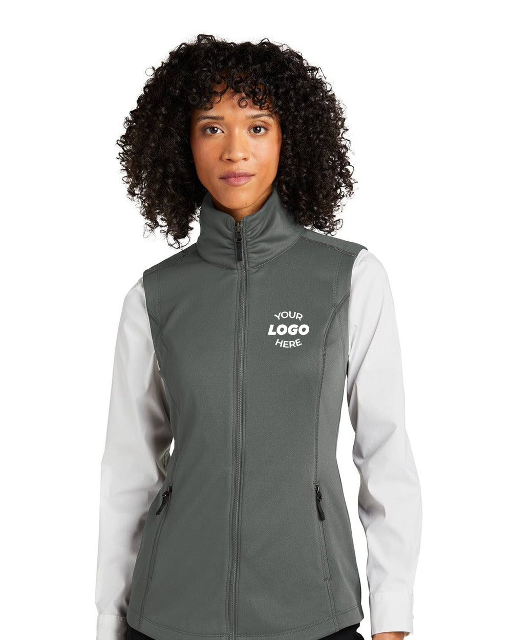 A woman models the Port Authority Ladies Collective Smooth Fleece Vest L906 in gray, featuring your custom logo on the left chest over a white shirt—ideal for highlighting personalized apparel against a plain background.