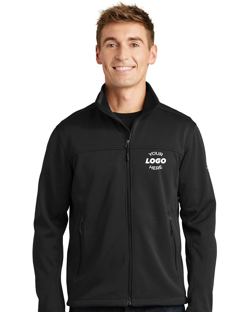 A person wearing a black The North Face Ridgewall Soft Shell Jacket NF0A3LGX, wind-resistant and featuring "Your Logo Here" text on the chest, stands against a plain white background.
