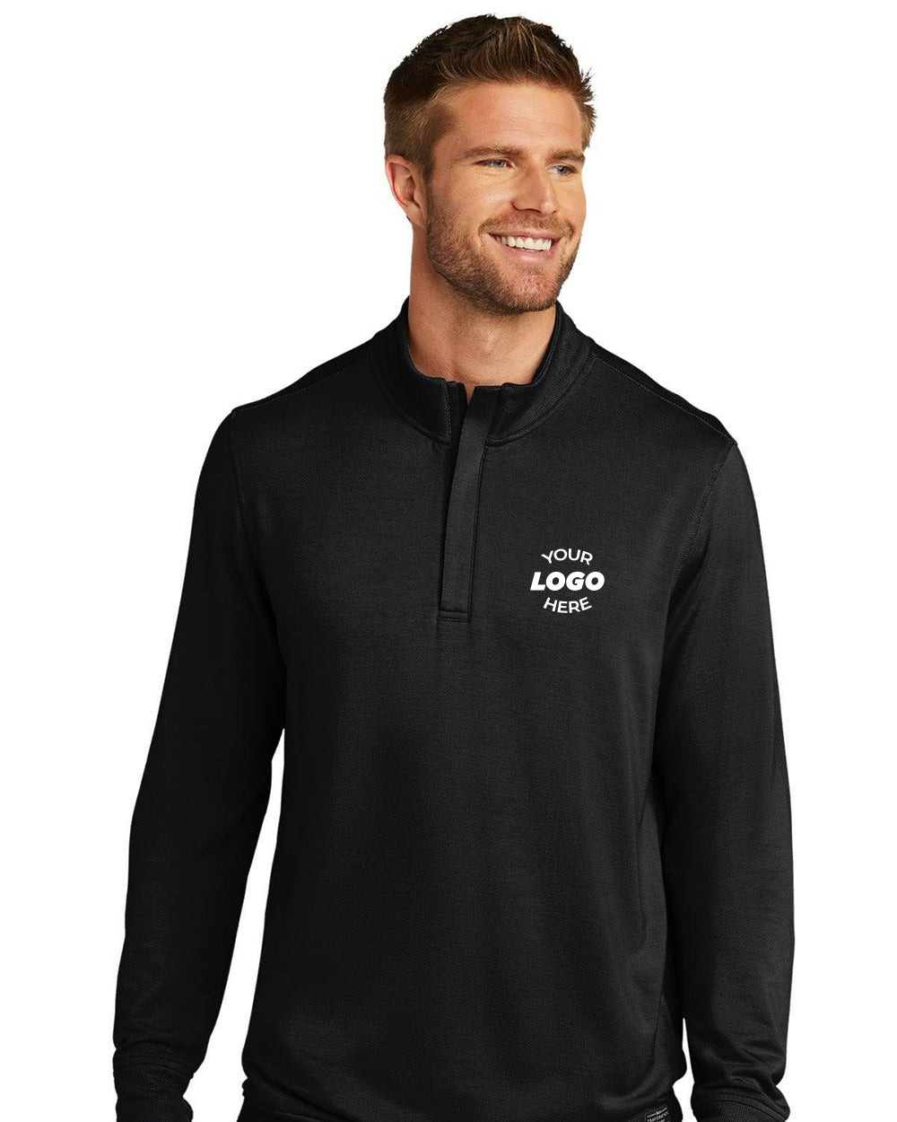 A man stands smiling in a TravisMathew Newport 1/4‑Zip Fleece Pullover TM1MU419 with "Your Logo Here" printed on the left chest.