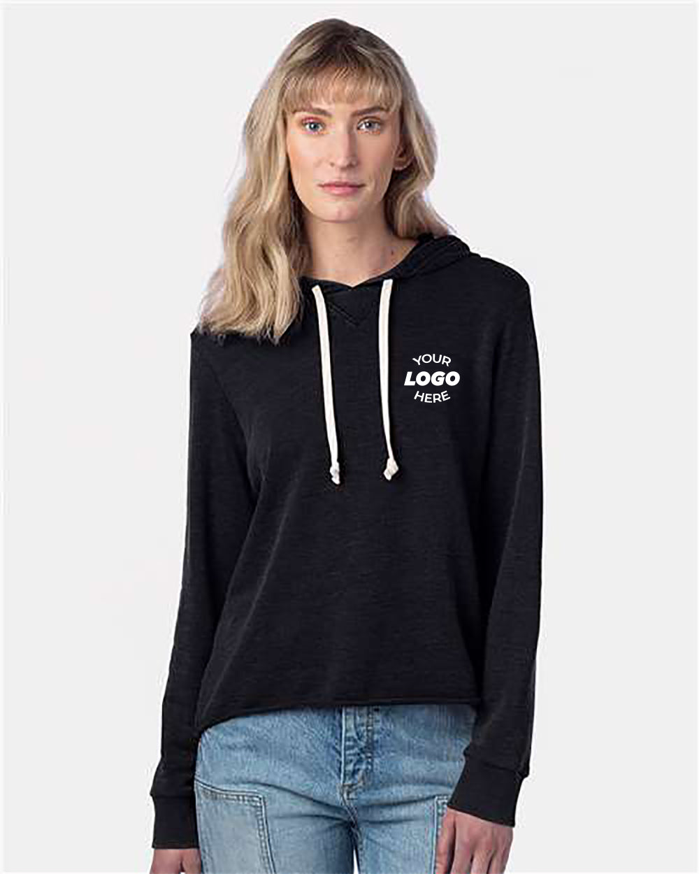 A person with light hair is wearing an Alternative Women Alternative Day Off Mineral Wash French Terry Hooded Sweatshirt in a dark color, featuring light drawstrings and custom text on the chest, paired with light blue jeans, standing against a plain background. Consider our bulk customized options for unique designs!