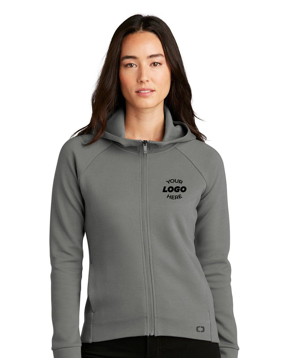 A woman models the OGIO Ladies Bolt Full-Zip Hoodie Sweatshirt (LOG850), featuring raglan sleeves, a gray color, and "YOUR LOGO HERE" printed on the left chest, against a plain white background.