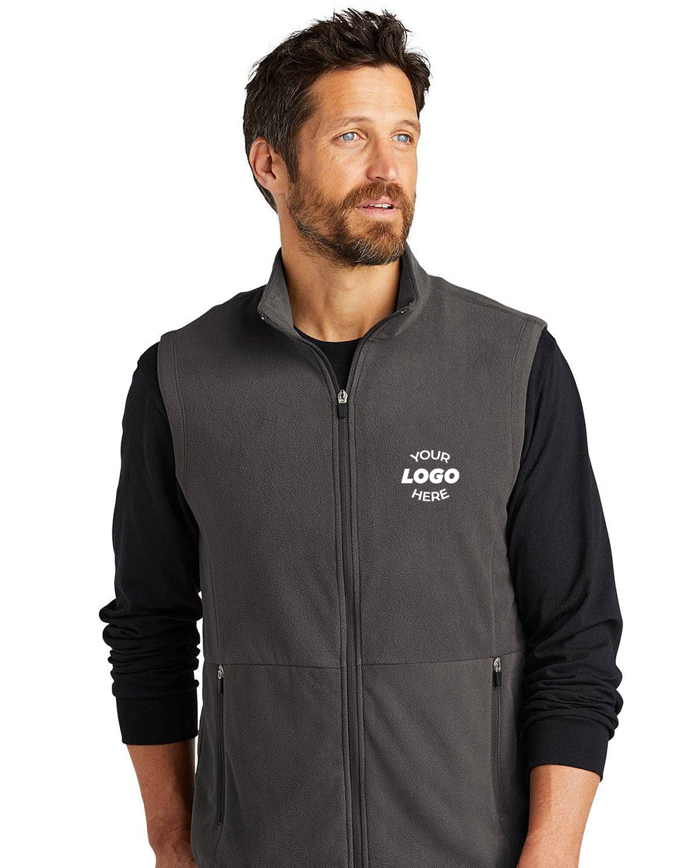 Man wearing a Port Authority Accord Microfleece Vest F152 in dark gray with reverse coil zippers over a black long-sleeve shirt, featuring "Your Logo Here" on the left chest.