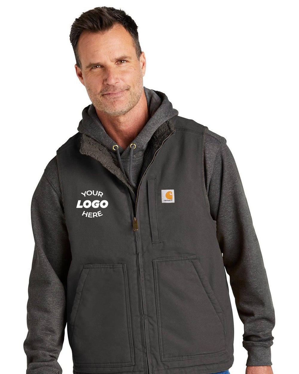 Man in a dark hoodie and Carhartt Sherpa-Lined Mock Neck Vest CT104277, featuring “Your Logo Here” on the left chest; he stands facing the camera—an ideal mix of warmth, comfort, and durable cotton duck from Carhartt.