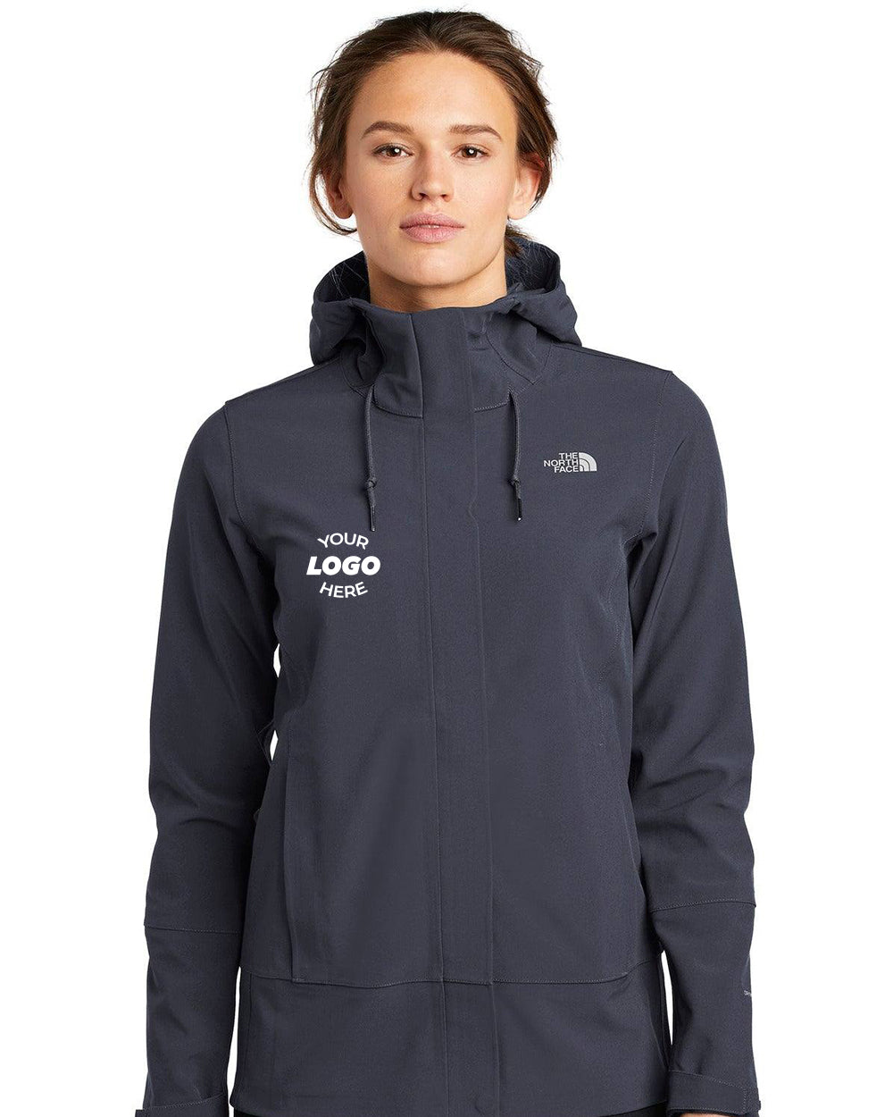 A person wearing a dark gray The North Face Ladies Apex DryVent Jacket NF0A47FJ, featuring "Your Logo Here" text on the chest and crafted from windproof material.