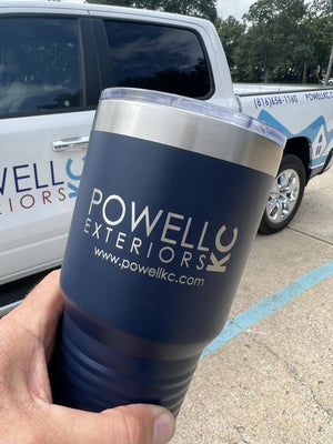 A hand holding a custom-engraved Kodiak Coolers insulated tumbler in front of a vehicle with matching branding.
