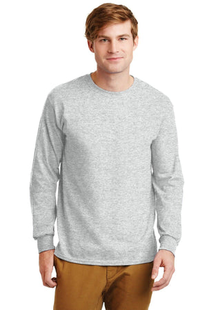A man faces forward in a Gildan 100% US Cotton Long Sleeve T-Shirt 2400 (Pack of 36, custom screen printed logo included) and tan pants, standing against a plain white background.