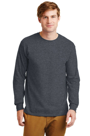 A man stands against a white background wearing tan pants and a dark gray Gildan 2400 long sleeve T-shirt, made from 100% US cotton, featuring a custom screen printed logo. (Pack of 36).
