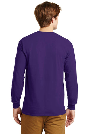 A man wearing a Gildan 100% US Cotton Long Sleeve T-Shirt 2400 in purple with custom screen printed logo and tan pants stands with his back to the camera against a plain background.