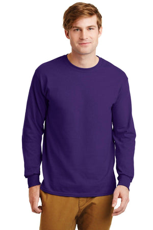A man wears a Gildan 100% US Cotton Long Sleeve T-Shirt 2400 (pack of 36, custom screen printed logo included) in purple and tan pants, facing the camera against a white background.