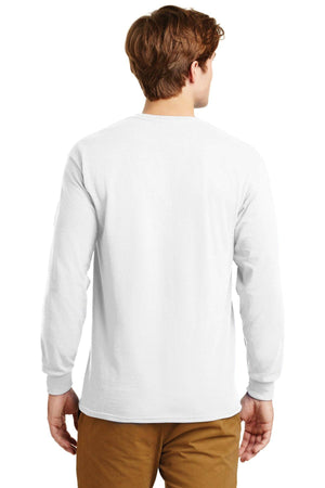 A man faces away from the camera, wearing light brown pants and a Gildan 100% US Cotton Long Sleeve T-Shirt (Pack of 36, style 2400) with a custom screen printed logo included.