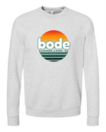 The designerapp "Bode Summer Bootcamp - OG Logo" unisex crewneck BC Fleece Raglan Sweatshirt 3901 features a retro gradient sun graphic with "bode" and "Summer Camp '26," crafted from pre-shrunk Airlume cotton for lasting comfort.