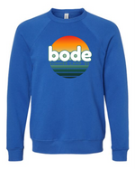 The designerapp Bode Summer Bootcamp "OG Logo" Unisex Crewneck BC Fleece Raglan Sweatshirt 3901 is a blue pre-shrunk fleece featuring a circular sunset "bode" and "SUMMER CAMP '26" graphic on the front.