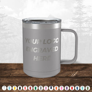 A TODAY ONLY - Hump Day Sale - Kodiak Coolers insulated mug custom engraved with your logo, displayed on a wooden surface against a blurred forest background.