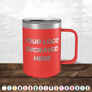 A red insulated mug with a handle, featuring the text "TODAY ONLY - Custom Logo Drinkware Sale - Your Logo Laser Engraved INCLUDED in Price - No Hidden Fee's" on a wooden surface, with a faded forest background by Kodiak Coolers.
