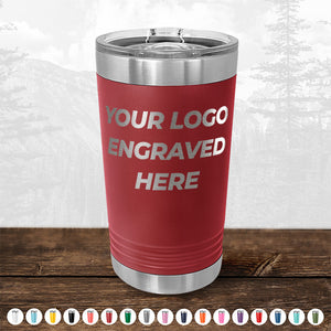 Customizable Kodiak Coolers red pint tumbler with a silver lid and an example text for logo placement on a wooden surface, featuring double-walled insulation.