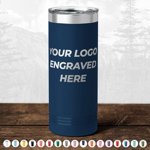 Blue insulated tumbler from Kodiak Coolers with "your logo engraved here" text, displayed against a soft-focus forest background—perfect as a promotional gift.