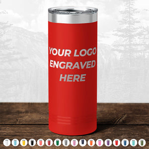 Red insulated tumbler with "your logo engraved here" text, displayed on a wooden table against a blurred forest background—ideal for promotional gifts featuring the TODAY ONLY - Custom Logo Drinkware Sale from Kodiak Coolers.