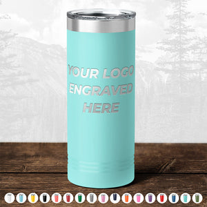 Aqua-colored insulated tumbler with TODAY ONLY - Hump Day Sale - Your Logo Engraved on Drinkware - Single Side Engraving Included in Price - Slider Lids Included displayed, resting on a wooden surface against a blurred forest background, perfect as a promotional gift from Kodiak Coolers.