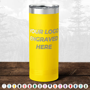 Yellow insulated tumbler with "TODAY ONLY - Hump Day Sale - Your Logo Engraved on Drinkware - Single Side Engraving Included in Price - Slider Lids Included" text, displayed on a wooden table against a blurred forest background by Kodiak Coolers.