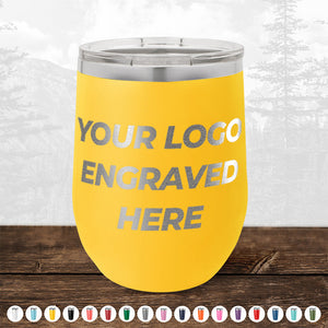 A yellow Kodiak Coolers PRIME BIG DAY DEALS tumbler with a silver lid and "Your Logo Engraved Here" is on a wooden surface, with other color options for custom laser-etched drinkware displayed below. No setup fees; fast turnaround.