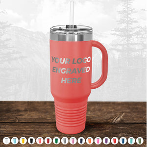 Promotional gift TODAY ONLY - Custom Logo Drinkware Sale red travel mug with "your logo engraved here" text, on a wooden surface, featuring a clear lid and metal straw, with blurred forest background. Brand Name: Kodiak Coolers