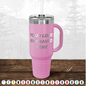 Pink insulated travel mug with "TODAY ONLY - Custom Logo Drinkware Sale - Your Logo Laser Engraved INCLUDED in Price - No Hidden Fee's" text, displayed with a metal straw, against a forest backdrop. A color palette below shows other color options by Kodiak Coolers.