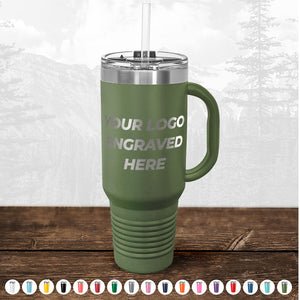A green insulated travel mug with "TODAY ONLY - Custom Logo Drinkware Sale - Your Logo Laser Engraved INCLUDED in Price - No Hidden Fee's" text, displayed with a straw and handle, set against a forest background. Various color options shown below.