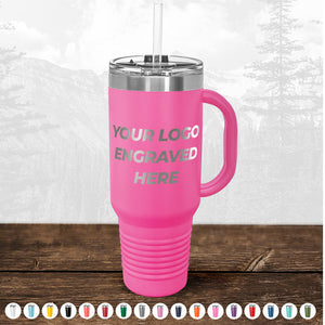 Pink insulated tumbler with a straw and "today only - custom logo drinkware sale - your logo laser engraved included in price - no hidden fee's" text, displayed on a wooden surface with a faded forest background. Color options below. (Brand: Kodiak Coolers)