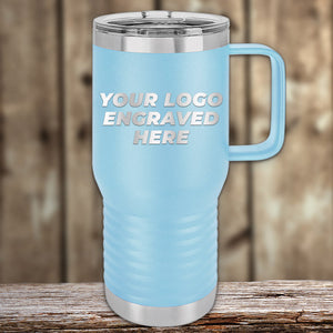 Blue Kodiak Coolers laser-engraved insulated stainless steel travel tumbler with customizable logo area displayed on a wooden surface against a wooden backdrop.