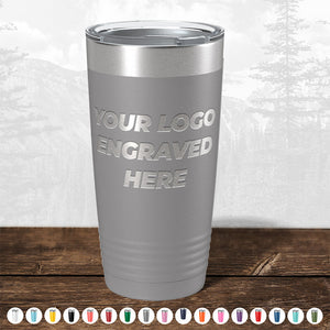 A TODAY ONLY - Hump Day Sale - Your Logo Engraved on Drinkware - Single Side Engraving Included in Price - Slider Lids Included tumbler with "your custom logo engraved here" text, placed on a wooden surface against a misty forest background.
