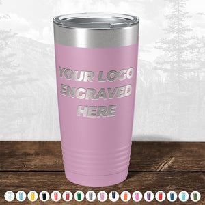 A pink insulated TODAY ONLY - Hump Day Sale - Your Logo Engraved on Drinkware - Single Side Engraving Included in Price - Slider Lids Included tumbler by Kodiak Coolers on a wooden surface with "your logo engraved here" text, displayed with color options below and a forest background, ideal as a promotional gift.