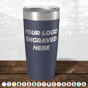 A navy blue Kodiak Coolers Custom Tumbler with your logo engraved on the front, shown with a clear lid and color options below—ideal for promotional gifts. No setup fees. $200 minimal order.