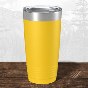A 20 oz yellow Kodiak Coolers tumbler with a laser-engraved Wisconsin Luxemburg Casco Spartans design sits on wood, mountain view behind—ideal school drinkware for standout brand promotion.