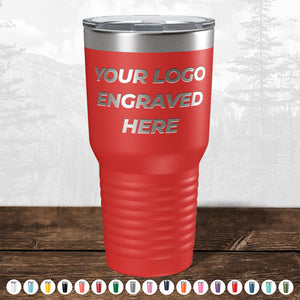 Red insulated tumbler with customizable logo space for promotional gifts, displayed on a wooden surface against a blurry forest background from TODAY ONLY - Custom Logo Drinkware Sale - Your Logo Laser Engraved INCLUDED in Price - No Hidden Fee's by Kodiak Coolers.