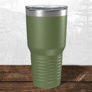A Kodiak Coolers 30 oz green tumbler with a clear lid, featuring a laser-engraved Wisconsin Luxemburg Casco Spartans school design, sits on wood with a subtle mountain backdrop—perfect for fans.