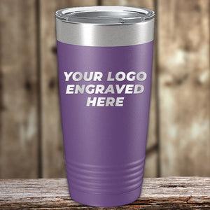 A purple Kodiak Coolers stainless steel tumbler with a silver rim, featuring the text "your logo laser engraved here" on a wooden surface.