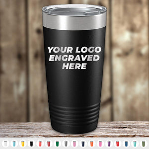 Stainless steel insulated tumbler from Kodiak Coolers, perfect as a corporate promotional gift, with a custom engraving area labeled "your logo engraved here" displayed on a wooden background.