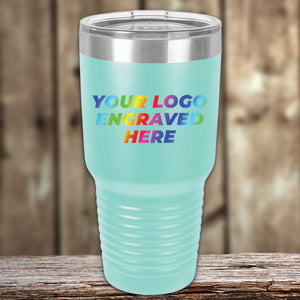 A turquoise tumbler with the words 'your logo engraved here'. This Kodiak Coolers custom tumbler serves as a corporate promotional gift option, and features a UV printed design.