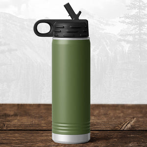 A Kodiak Coolers 20 oz water bottle with flip top straw, laser engraved with the Wisconsin Luxemburg Casco Spartans design, sits on wood with blurred mountains in the background, reflecting school pride and adventure.