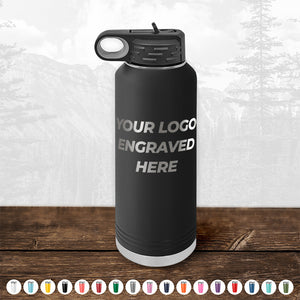 A black insulated Kodiak Coolers custom water bottle with a customizable engraving area displayed on a wooden surface.