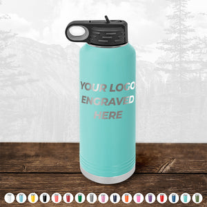 Aqua-colored Kodiak Coolers water bottle with engraved logo space on wooden surface.