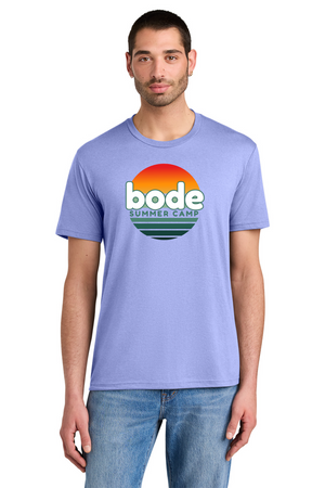 Man wearing a Printify 2026 Bode Summer Bootcamp OG Logo Unisex Tri Blend T-Shirt (DM130) in light purple with sunset graphic and "bode SUMMER CAMP" text on front, paired with blue jeans.