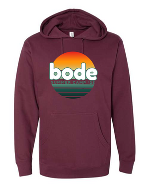 The Printify 2026 Bode Summer Bootcamp OG Logo Hoodie by Independent Trading Co. is maroon, featuring a round sunset graphic with "bode" and "SUMMER CAMP '26" text on the front.