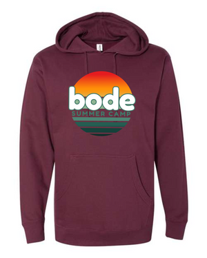 The 2026 Bode Summer Bootcamp OG Logo Hoodie Sweatshirt by Printify features a maroon cotton-poly fleece, adjustable hood, front pocket, and circular sunset-style “bode SUMMER CAMP” logo. Made with Independent Trading Co. SS4500.