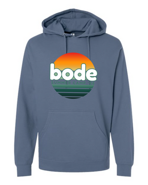 The Printify 2026 Bode Summer Bootcamp OG Logo Hoodie (Unisex SS4500) is a blue cotton-poly fleece sweatshirt with a front pocket, adjustable hood, sunset graphic and "bode SUMMER CAMPS" print—delivering comfort and style all season.