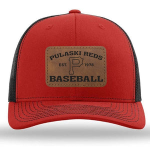 The designerapp Pulaski Reds Baseball Richardson 112 snapback trucker cap features a red and black mesh design with a leather patch that reads "Pulaski Reds Est. 1978 Baseball" and displays a large "P" logo.