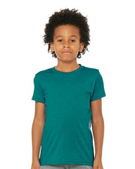 A young boy wearing a BELLA + CANVAS Youth Triblend T-Shirt, a high-quality, comfortable green t-shirt made with triblend material.